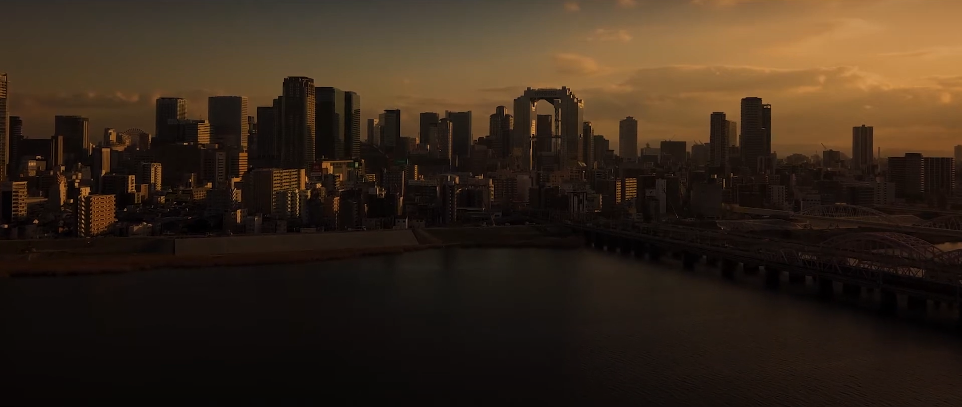 The featured images are captured using drone technology, showcasing the cityscape of Osaka. These high-resolution aerial shots highlight the intricate details of the urban landscape at sunset, providing a unique perspective that stimulates visual sensation.