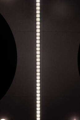 Image of close-up view of a modern led light fixture on a textured ceiling, showcasing its rectangular pattern and contemporary design. ideal for office lighting and interior design themes.