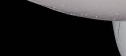 Image of close-up of a modern lamp with a sleek, white surface against a dark background, showcasing water droplets and subtle texture. ideal for interior design themes focusing on contemporary lighting, minimalist decor, and sophisticated home accessories.