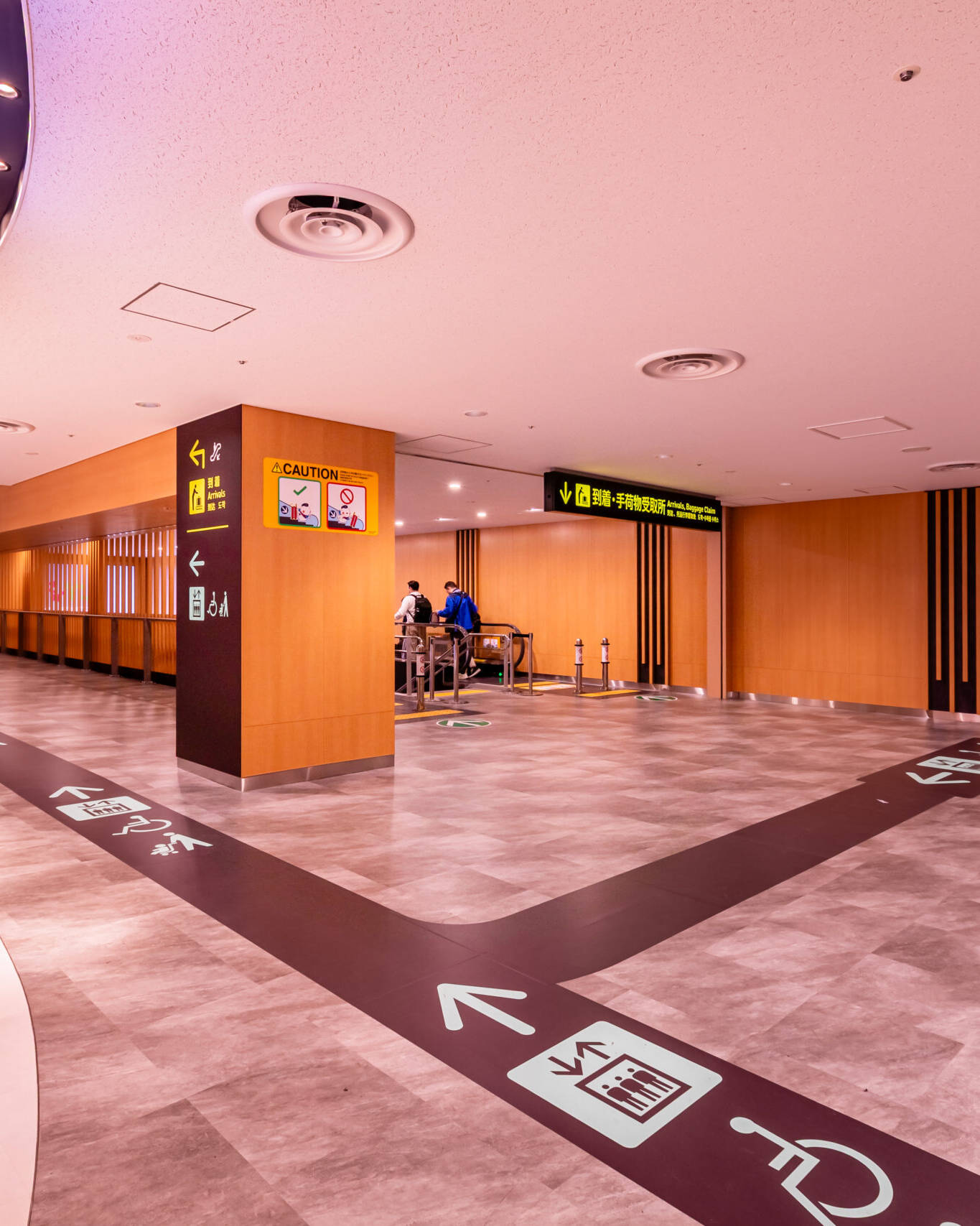 Image of modern airport corridor with clear directional signage and elevator access, featuring spacious layout and polished flooring. provides easy navigation for travelers, including accessibility options. ideal for safe, efficient transit in busy airport environments.