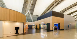 Image of modern airport terminal interior featuring sleek, contemporary design elements. the scene includes a lawson convenience store with brightly lit signage and stylish architectural lines. the spacious layout and polished flooring highlight the terminal's sophisticated ambiance, ideal for travelers seeking convenience and aesthetics at international airports
